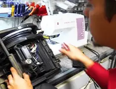 Vacuum repair technician servicing internal components on a workbench in San Antonio, TX