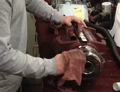 Vacuum repair technician cleaning and servicing a vacuum motor in San Antonio, TX