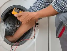 Washing machine repair technician testing a front-load washer with diagnostic tools in San Antonio, TX